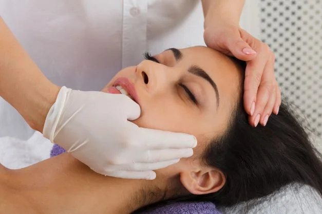 A woman receiving a bruxism massage