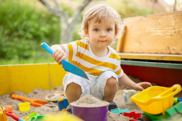 child playing in sand