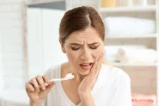 Woman with sensitive teeth after a filling